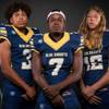 Members of the Democracy Prep High football team pose for a photo at the Las Vegas Sun's high school football media day Tuesday July 31, 2018 at the Red Rock Resort and Casino. They include, from left,  Kelley Jones, Vanell Meeks and Micah Gayman.
