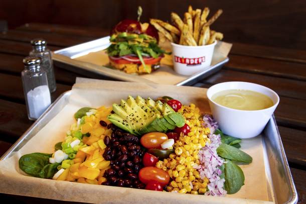 The Southwest Avocado Monsoon salad (front) and Cha Cha Burger with Rosemary Fries (back) from Blinders Burgers & Brunch