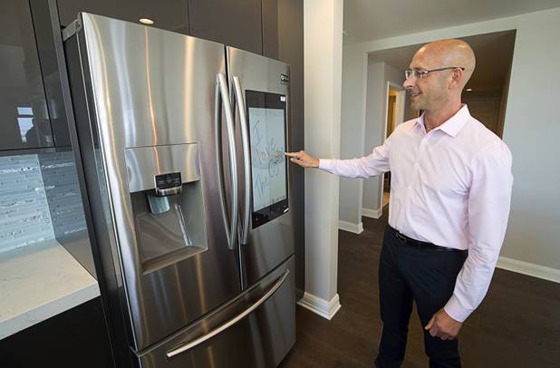 Uri Vaknin, a partner in KRE Capital, writes a digital note on an Internet-enabled Samsung refrigerator in a remodeled condo at the Ogden in downtown Las Vegas Tuesday, Aug. 21, 2018.