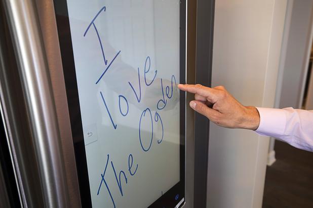 Uri Vaknin, a partner in KRE Capital, writes a digital note on an Internet-enabled Samsung refrigerator in a remodeled condo at the Ogden in downtown Las Vegas Tuesday, Aug. 21, 2018.