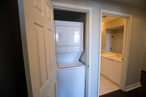 A small washing machine and dryer are hidden in a closet of a two-bedroom condo in the Ogden in downtown Las Vegas Thursday, Aug. 16, 2018.