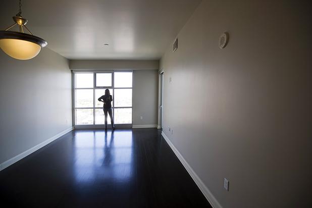 Condominium specialist Darcy Barajas looks out the window of a two-bedroom condo in the Ogden in downtown Las Vegas Thursday, Aug. 16, 2018.
