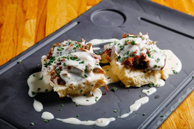 Biscuits and gravy with duck confit meat prepared by Chef Kevin Lopez, are seen here at Andre's Bistro and Bar, Thursday, Aug. 14, 2018.