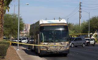 Metro Police vehicles are shown by an RTC bus during an officer-involved shooting investigation near Spring Mountain Road and Rainbow Boulevard Friday, Aug. 24, 2018. Police shot a man who is accused of randomly stabbing two women.