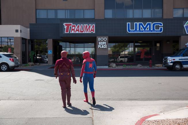 Critical Care Comics' Chase Addison, as The Flash, and Michael Mutzhause, as Spider-Man, head in to UMC's Children's Hospital to deliver comic books and toys to kids, Sat Aug. 18, 2018.