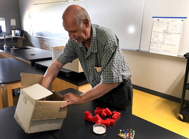 Clark County School District math teacher John Perri, 71, unpacks his teaching puzzles inside his classroom at Southwest Career and Technical Academy, Friday, August 10, 2018.