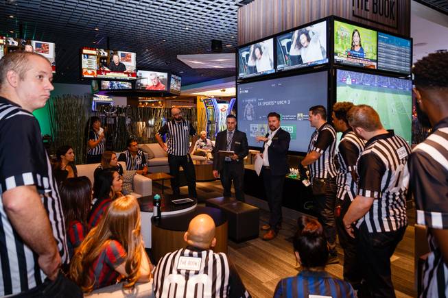 Employees hold a meeting at a new sports book and bar called The Book inside The LINQ, Wednesday, Sep. 5, 2018.