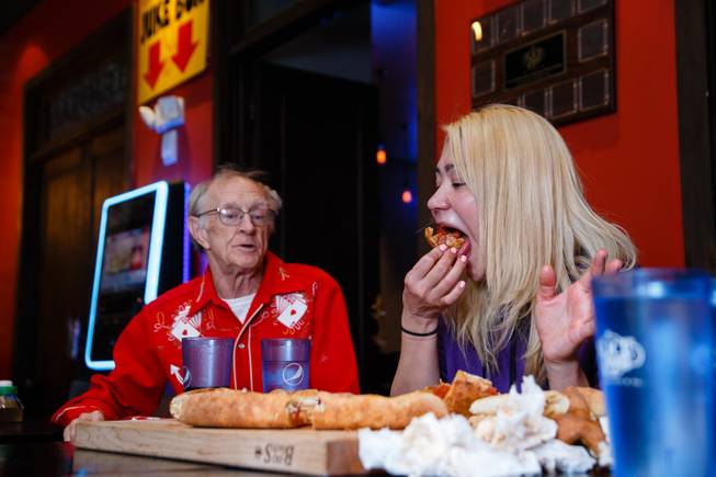Competitive eater Miki Sudo, with fellow competive eater Rich LeFevre at her side, attempts Slice of Vegas Double Down Pizza Challenge inside Mandalay Bay, Thursday, Sep. 6, 2018. LeFevre completed the challenge in 38 minutes the day before.