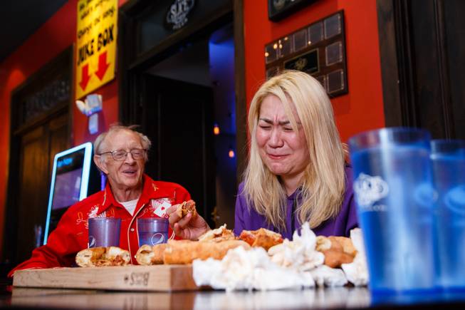 Competitive eater Miki Sudo, with fellow competive eater Rich LeFevre at her side, attempts Slice of Vegas Double Down Pizza Challenge inside Mandalay Bay, Thursday, Sep. 6, 2018. LeFevre completed the challenge in 38 minutes the day before.