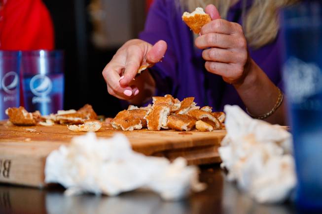 Competitive eater Miki Sudo breaks apart pizza crusts as she attempts Slice of Vegas Double Down Pizza Challenge inside Mandalay Bay, Thursday, Sep. 6, 2018. The challenge, which has never been conquered by any regular customer, consists of eating a 7 pound pizza in under an hour.