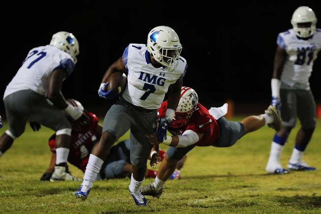 Liberty player Kyle Beaudry attempts to tackle IMG Academy running back Noah Cain during a game at Liberty High School, Friday, Sept. 7, 2018.