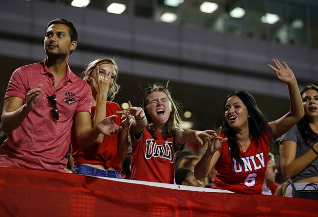 UNLV fans pose for a video cameraman during a game against UTEP at Sam Boyd Stadium Saturday, Sept. 8, 2018.