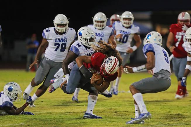 Liberty running back Zyrus Fiaseu (30) gets tackled while running the ball during a game against IMG Academy at Liberty High School, Friday, Sep. 7, 2018.