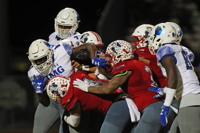 IMG Academy running back Trey Sanders (6) drags the pile during a game against Liberty at Liberty High School, Friday, Sep. 7, 2018.