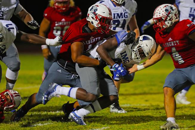 Liberty players tackle IMG Academy running back Trey Sanders (6) during a game at Liberty High School, Friday, Sep. 7, 2018.