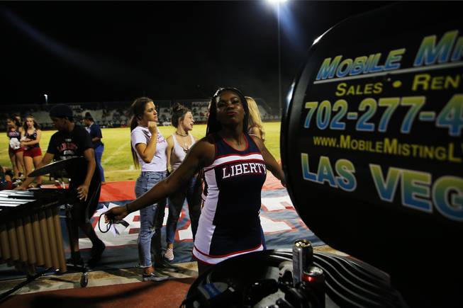 A Liberty cheerleader cools off during a game against IMG Academy, Friday, Sep. 7, 2018.