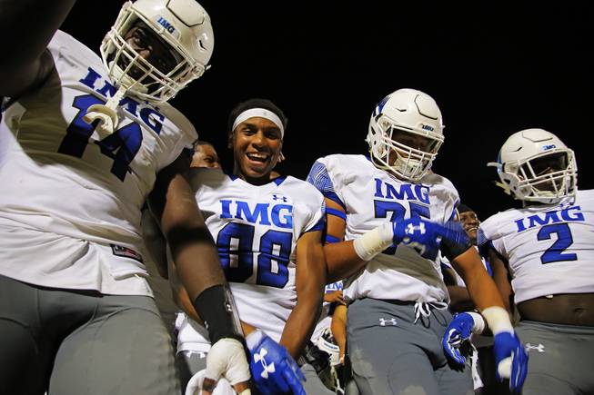 IMG Academy players celebrate after defeating Liberty 35-0 at Liberty High School, Friday, Sep. 7, 2018.