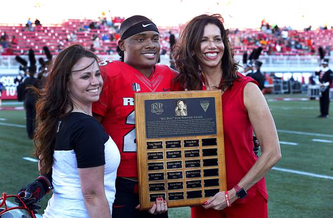 Amanda Koeller, head brewer for Big Dogs, and UNLV Athletic Director Desiree Reed-Francois, presents the "Big Dog" Tom Wiesner Award to defensive back Jocquez Kalili before a game against UTEP at Sam Boyd Stadium Saturday, Sept. 8, 2018. The award is given given to UNLV football players who have Wiesner's "courage, enthusiasm, dedication and toughness."