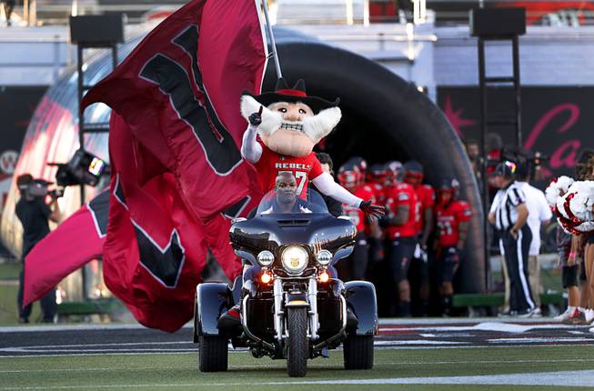 UNLV mascot Hey Reb leads the team as they take the field for a game against UTEP at Sam Boyd Stadium Saturday, Sept. 8, 2018.