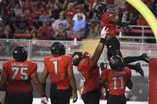 UNLV Rebels running back Lexington Thomas (3) is lifted up after scoring against the UTEP Miners during their NCAA football game Saturday, September 8, 2018, at Sam Boyd Stadium in Las Vegas.