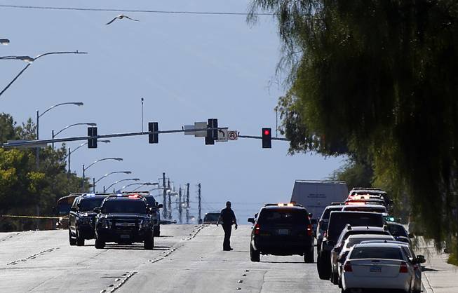 Police vehicles are shown on Alexander Road after a shooting at a ball field at Canyon Springs High School in North Las Vegas Tuesday, Sept. 11, 2018. One person was killed in the shooting.