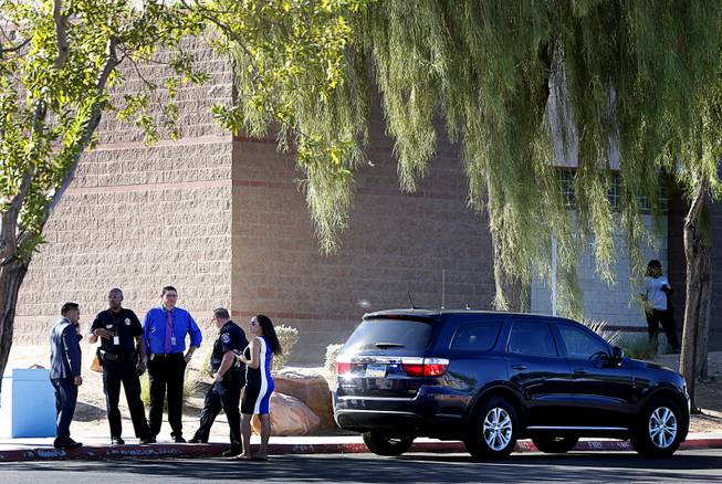 Police and officials with the Clark County School District and North Las Vegas Police confer after a fatal shooting at a ball field at Canyon Springs High School in North Las Vegas Tuesday, Sept. 11, 2018. 