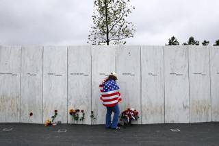 Chrissy Bortz of Latrobe, Pa., pays her respects at the Wall of Names at the Flight 93 National Memorial in Shanksville, Pa. after a Service of Remembrance Tuesday, Sept. 11, 2018, as the nation marks the 17th anniversary of the Sept. 11, 2001 attacks. The Wall of Names honor the 40 people killed in the crash of Flight 93. (AP Photo/Gene J. Puskar)