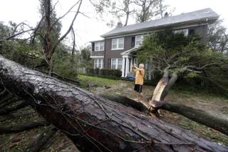 Mike Kiernan takes photos of the damage to his home in Wilmington, N.C., after Hurricane Florence made landfall Friday, Sept. 14, 2018. (AP Photo/Chuck Burton)
