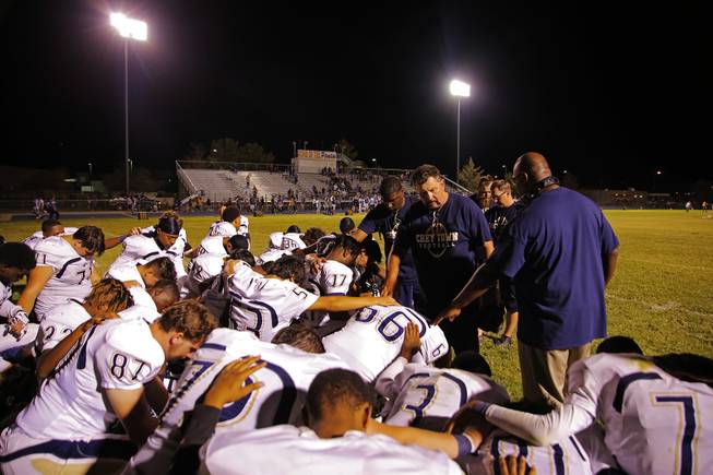 Cheyenne coach Patrick Ward has a post game prayer with his players after they are defeated by Moapa Valley 21-6, Friday, Sep. 14, 2018.