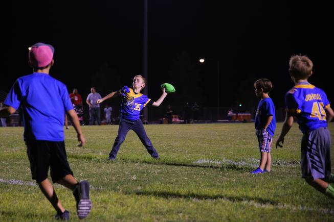 Children play on the field after a Moapa Valley vs Cheyenne game at Moapa Valley High School, Friday, Sep. 14, 2018.