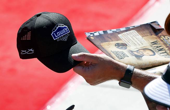 A Jimmie Johnson fan holds out a cap to be autographed as drivers make their way to a pre-race meeting before the South Point 400 NASCAR Cup series race at the Las Vegas Motor Speedway Sunday, Sept. 16, 2018.