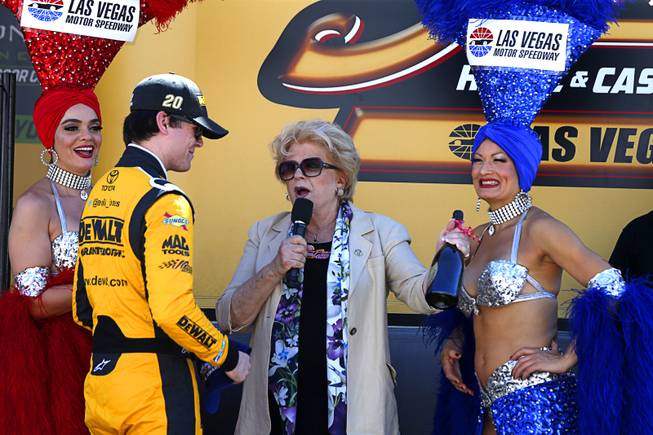 Las Vegas Mayor Carolyn Goodman gives a bottle of Dom Perignon champagne to pole winner Erik Jones during the South Point 400 NASCAR Cup series race at the Las Vegas Motor Speedway Sunday, Sept. 16, 2018.