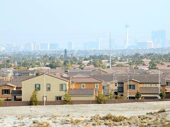 The Las Vegas skyline and homes are shown from over the ridge of a construction site for a new residential community at the edge of North Las Vegas, Aug. 11, 2018. 