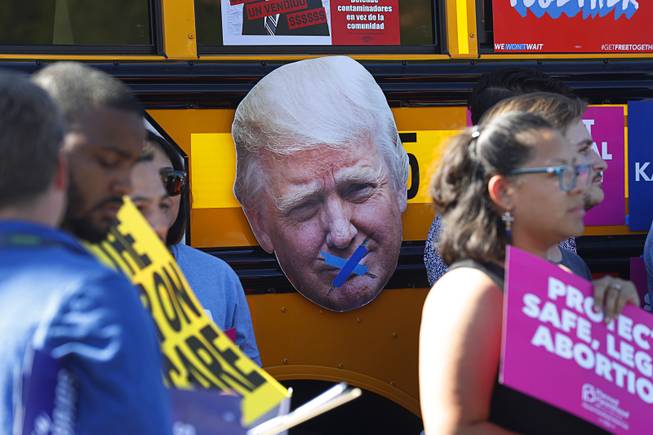 An image of President Donald Trump is displayed during a "Hop on the Progress Bus" news conference in an office park parking lot on West Sahara Avenue Wednesday, Sept. 19, 2018. A coalition of progressive groups joined to hold the news conference a day before President Trump's visit to Las Vegas.