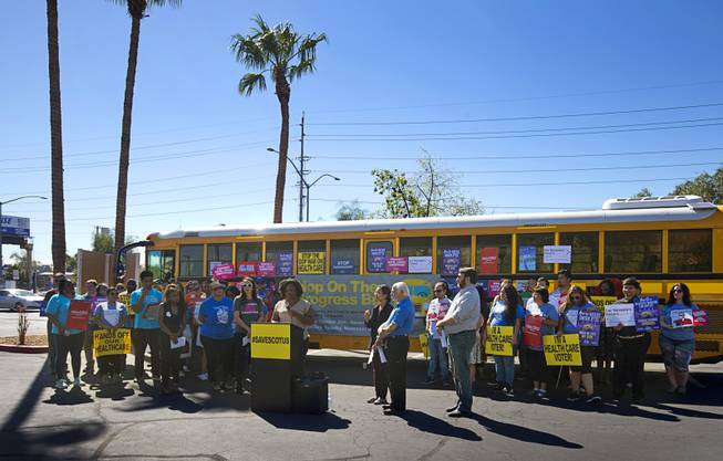 A coalition of progressive groups gather for a "Hop on the Progress Bus" news conference in an office park parking lot on West Sahara Avenue Wednesday, Sept. 19, 2018.