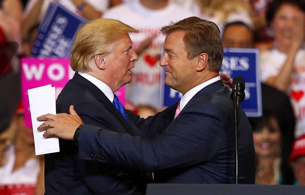 President Donald Trump embraces Sen. Dean Heller, R-Nev., during a rally at the Las Vegas Convention Center Thursday, Sept. 20, 2018. 