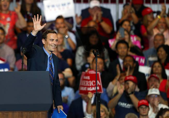 Nevada Attorney General Adam Laxalt, Republican candidate for governor, waves after speaking at President Donald Trump's "Make America Great Again (MAGA) rally at the Las Vegas Convention Center Thursday, Sept. 20, 2018.