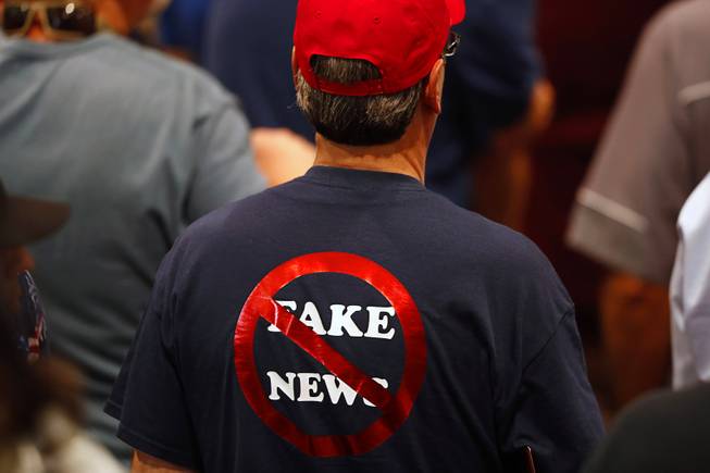A Trump supporter wears a "no fake news" T-shirt at a "Make America Great Again (MAGA) rally at the Las Vegas Convention Center Thursday, Sept. 20, 2018.
