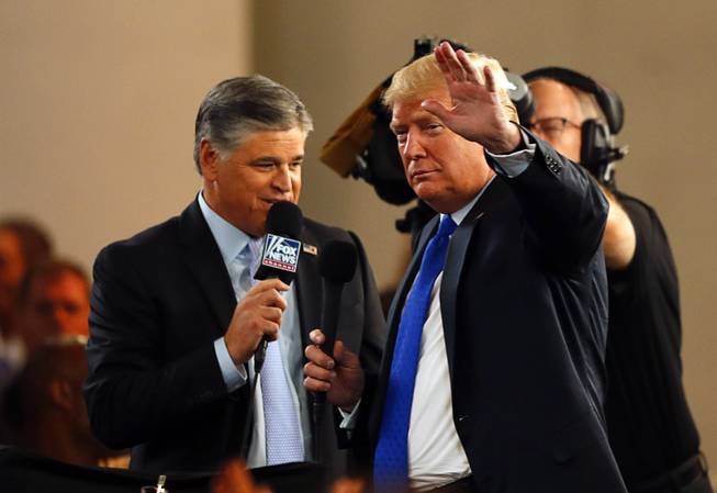 President Donald Trump waves to the crowd as he does a pre-rally interview with Fox's Sean Hannity at a "Make America Great Again (MAGA) rally at the Las Vegas Convention Center Thursday, Sept. 20, 2018.