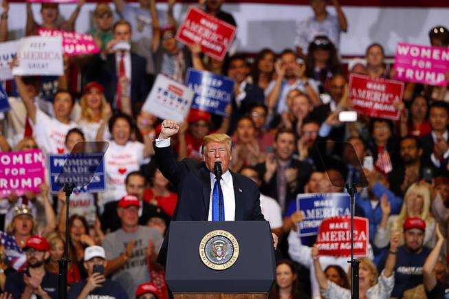 President Donald Trump raises his fist as he concludes a "Make America Great Again (MAGA) rally at the Las Vegas Convention Center Thursday, Sept. 20, 2018.