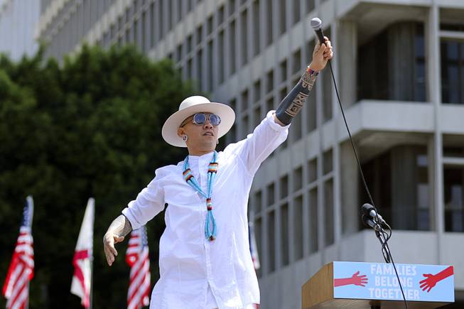 In this June 30, 2018 file photo, Taboo from Black Eyed Peas performs "Where is the Love?" at the "Families Belong Together: Freedom for Immigrants" March in Los Angeles. The Black Eyed Peas tackle gun violence at schools and immigration in two new music videos for their song, "Big Love." The trio released the videos Friday, Sept. 21, 2018.