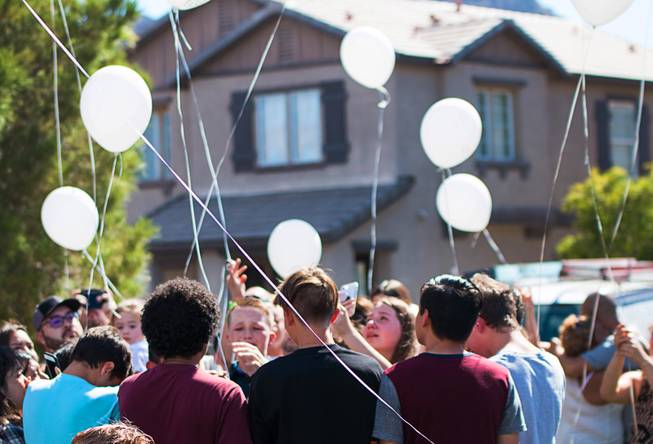 Mourners hold white balloons at the Liberty At Paradise Community in Henderson Saturday Sept. 22. They were there to honor  Selina Rowsell, her son, Arias, and his younger brother, Avi. The three were slain Sept. 20 in the same community by a perpetrator who then took his own life.