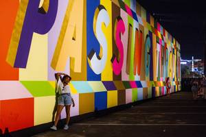 Festivalgoers have their picture taken in front of one of the many murals that can be found throughout the festival grounds during the first day of the Life is Beautiful music festival in downtown Las Vegas, Friday, Sept. 21, 2018.