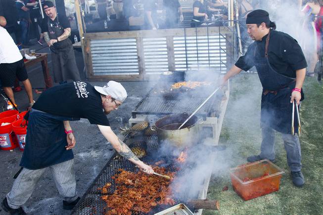 Chef Justin Kingsley Halls crew from Atomic Kitchen restaurant grill meet at the Cookout tent during the second day of the Life is Beautiful music festival in downtown Las Vegas, Saturday, Sept. 22, 2018.
