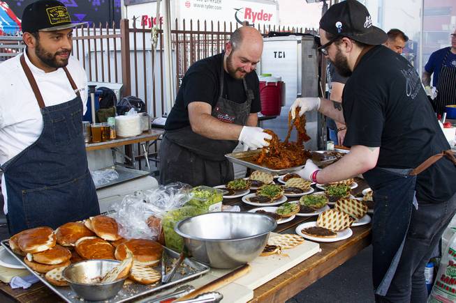 Chef Justin Kingsley Halls crew from Atomic Kitchen restaurant prepare sandwiches at the Cookout tent during the second day of the Life is Beautiful music festival in downtown Las Vegas, Saturday, Sept. 22, 2018.