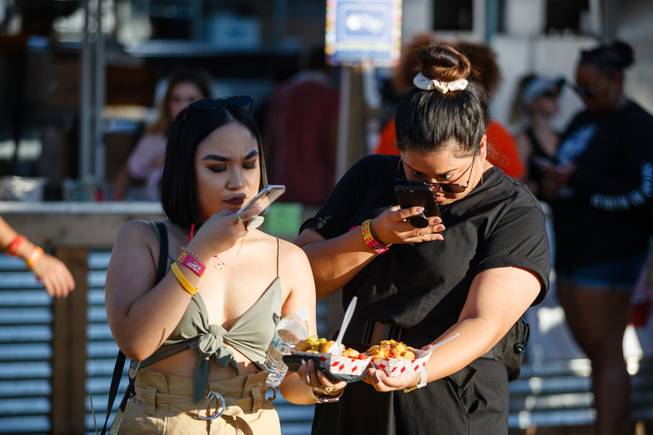 Festivalgoers take food photos during day three of the Life is Beautiful music festival in downtown Las Vegas, Sunday, Sept. 23, 2018.