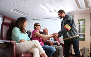 The French forward and his wife Hannah have been spending time with patients at local clinics.
