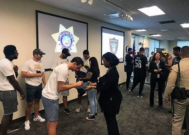 Players from the Golden Knights and Raiders mingle with Metro Police staff at a meet and greet at department headquarters, Tuesday, Oct. 2, 2018.