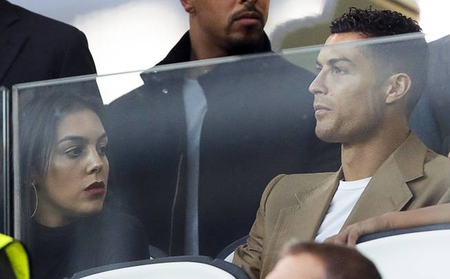 Juventus forward Cristiano Ronaldo and his partner Georgina sit in the stands prior to the Champions League match between Juventus and Young Boys, at the Allianz stadium in Turin, Italy, Tuesday, Oct. 2, 2018. 