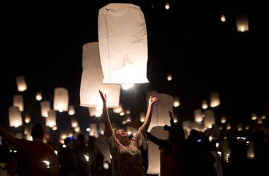 A woman releases her lantern during the 2018 Rise Festival at Jean Dry Lake Bed.